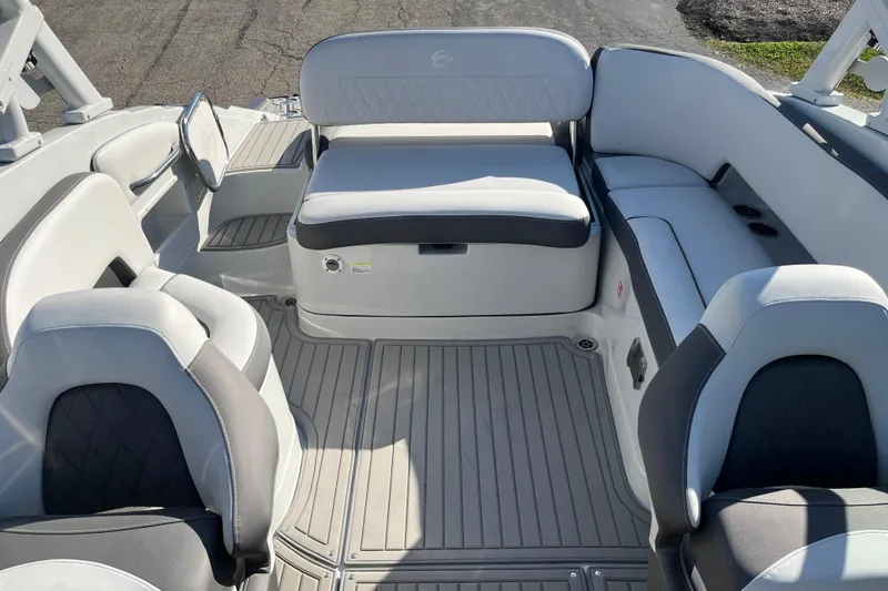Slide: The Image of 2026 Crownline Eclipse E235 boat interior with gray seating and flooring. - 14