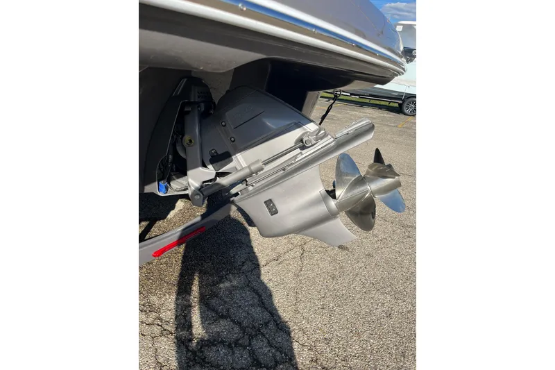 Slide: The Image of 2026 Crownline Eclipse E235 boat propeller and drive system on pavement. - 19