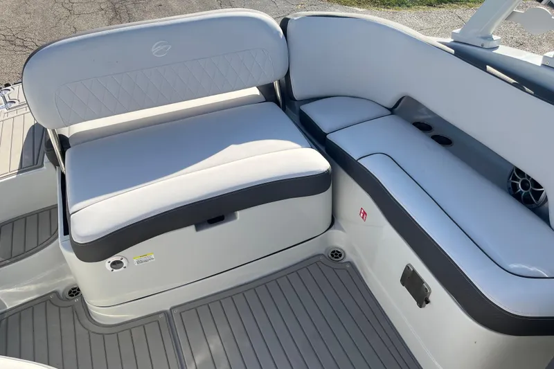 Slide: The Image of 2026 Crownline Eclipse E235 boat interior with white cushioned seating and gray flooring. - 5