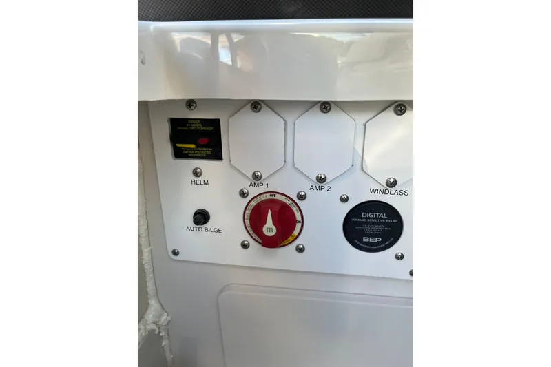 Slide: The Image of Control panel of 2026 Crownline Eclipse E235 boat with switches and circuit breakers. - 7