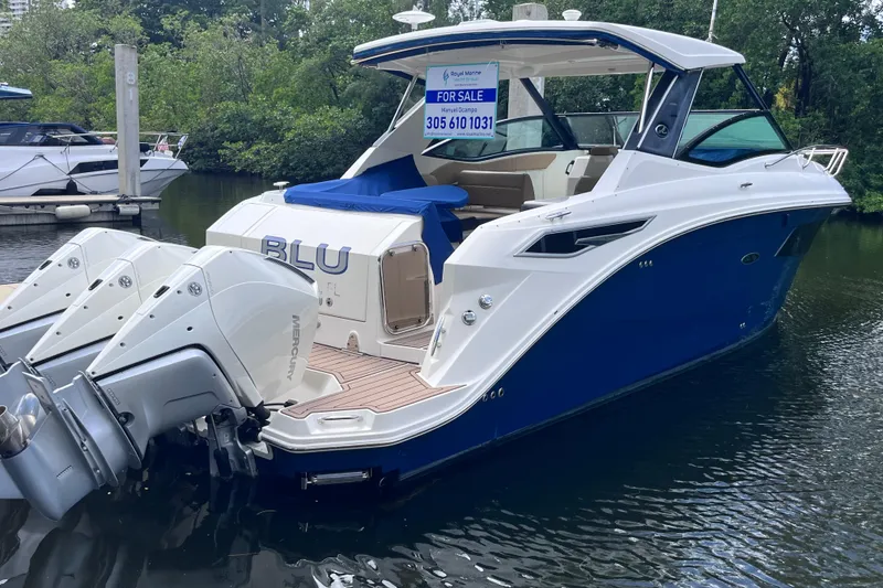 Slide: The Image of 2020 Sea Ray Sundancer 320 Outboard boat for sale, docked with triple Mercury engines. - 2