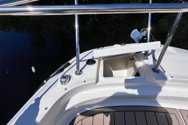Slide: The Image of 2020 Sea Ray Sundancer 320 Outboard bow with open storage compartment and railing. - 28