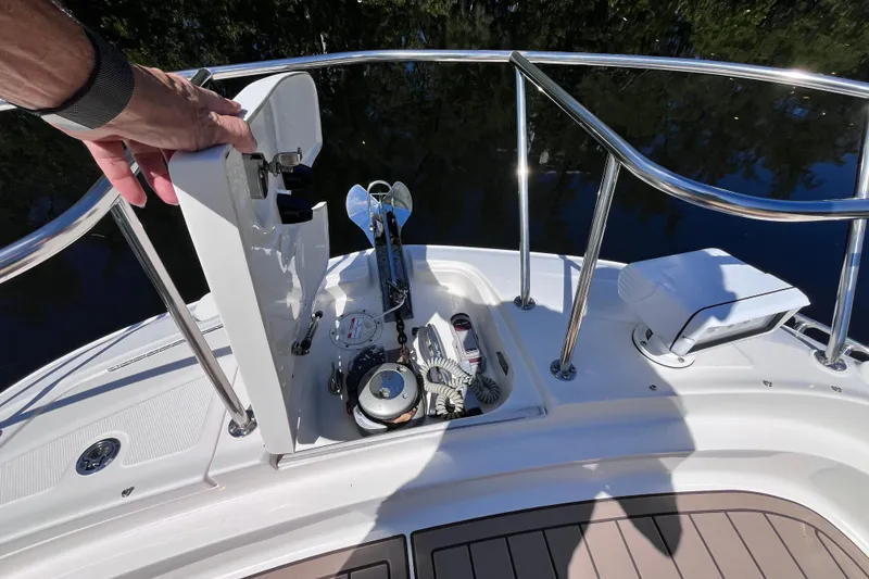 Slide: The Image of 2020 Sea Ray Sundancer 320 Outboard anchor compartment with open hatch and railing. - 29