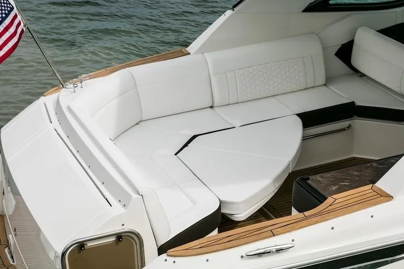 Slide: The Image of Manufacturer Provided Image: 2020 Sea Ray Sundancer 320 OB boat with white cushioned seating and wooden accents. - 34