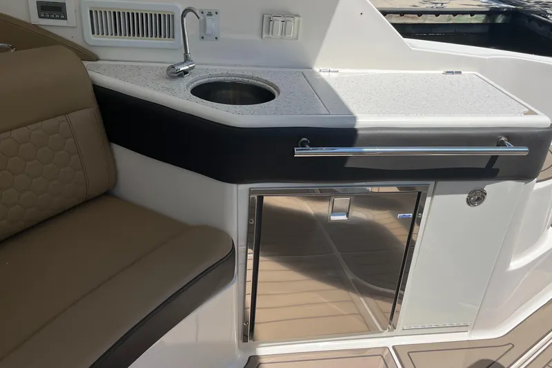 Slide: The Image of 2020 Sea Ray Sundancer 320 Outboard interior with sink, countertop, and seating. - 36