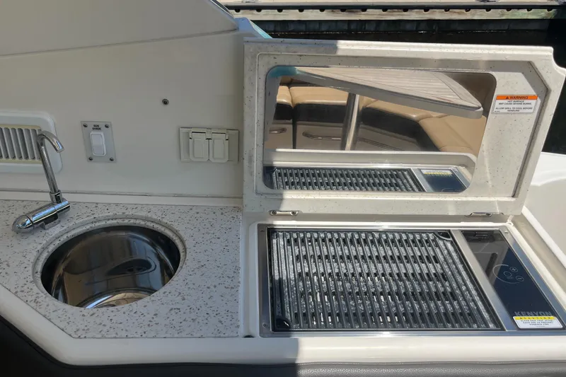 Slide: The Image of 2020 Sea Ray Sundancer 320 Outboard boat kitchen with sink and grill. - 38