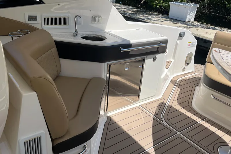 Slide: The Image of 2020 Sea Ray Sundancer 320 Outboard interior with seating, sink, and storage. - 39