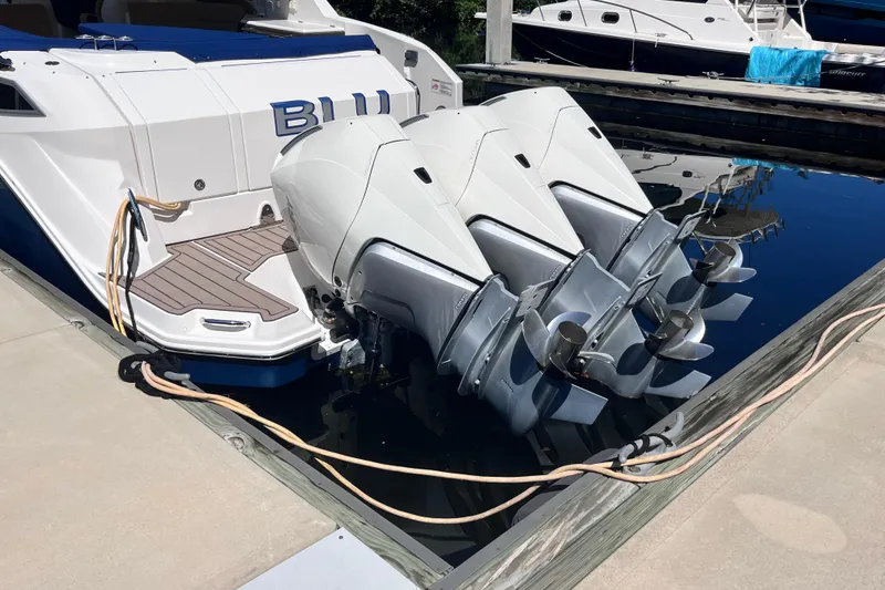 Slide: The Image of 2020 Sea Ray Sundancer 320 Outboard with triple engines docked at marina. - 4