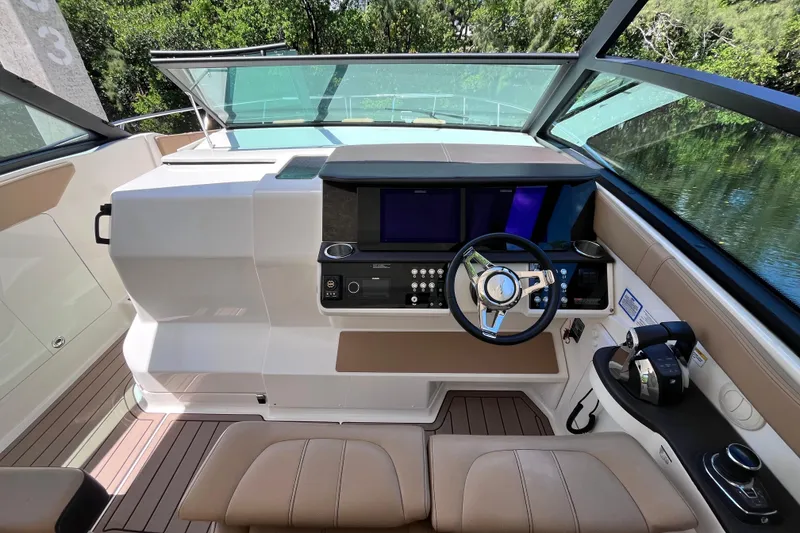 Slide: The Image of 2020 Sea Ray Sundancer 320 Outboard helm with modern controls and sleek design. - 45