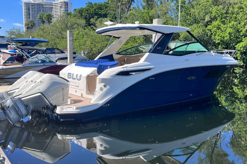 Slide: The Image of 2020 Sea Ray Sundancer 320 Outboard docked, reflecting on calm water. - 5