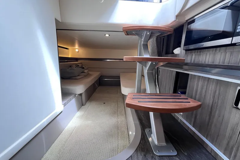 Slide: The Image of 2020 Sea Ray Sundancer 320 Outboard interior with modern staircase and cozy seating area. - 52
