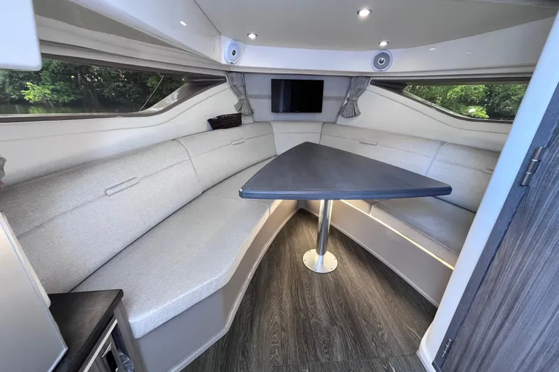 Slide: The Image of 2020 Sea Ray Sundancer 320 Outboard interior with sleek seating and modern table design. - 54