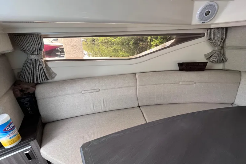 Slide: The Image of Interior of 2020 Sea Ray Sundancer 320 Outboard with beige seating and window view. - 56