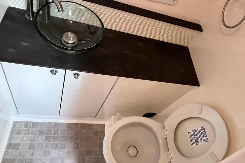 Slide: The Image of 2020 Sea Ray Sundancer 320 Outboard bathroom with modern sink and toilet. - 63