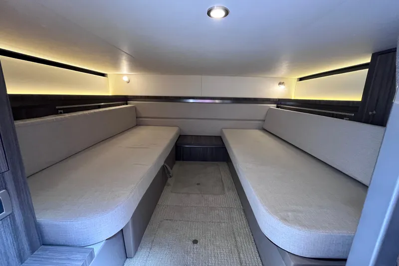 Slide: The Image of 2020 Sea Ray Sundancer 320 Outboard cabin interior with modern seating and ambient lighting. - 65