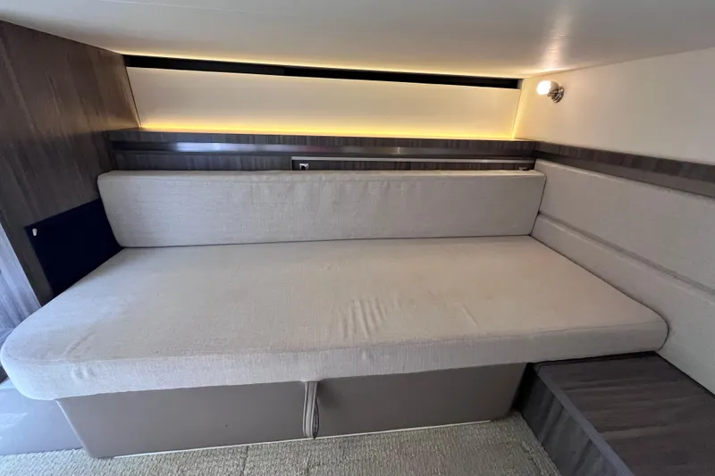 Slide: The Image of 2020 Sea Ray Sundancer 320 Outboard interior cabin with cushioned seating and ambient lighting. - 66