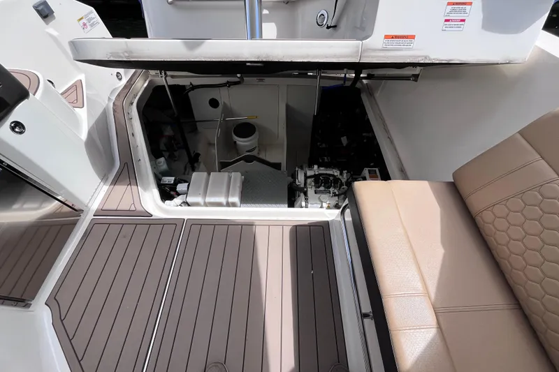 Slide: The Image of 2020 Sea Ray Sundancer 320 Outboard engine compartment with open hatch and seating area. - 70