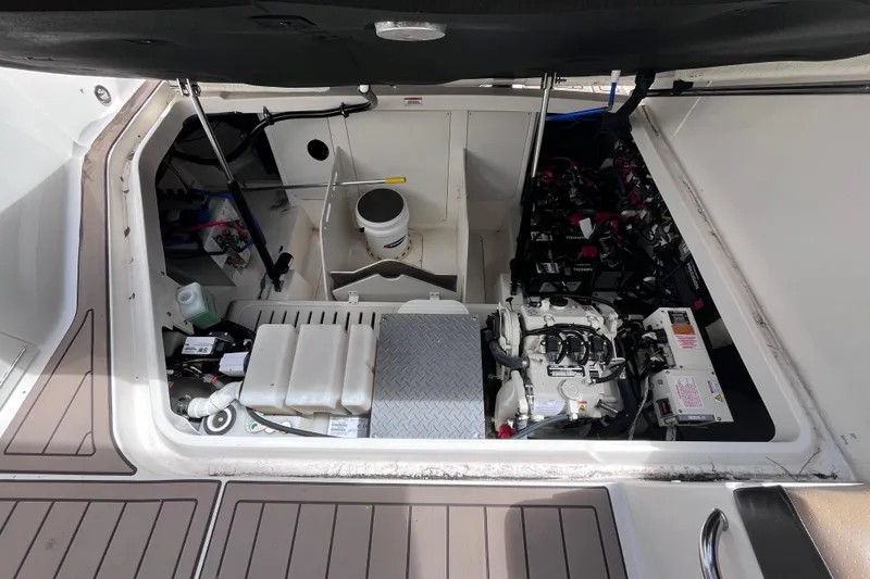 Slide: The Image of Engine compartment of 2020 Sea Ray Sundancer 320 Outboard, showcasing mechanical components and storage. - 71