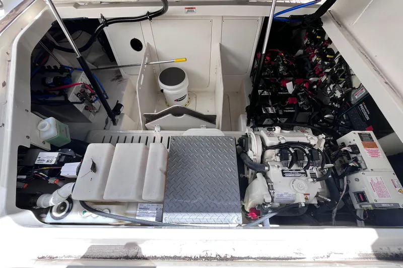 Slide: The Image of Engine compartment of a 2020 Sea Ray Sundancer 320 Outboard, showcasing mechanical components and wiring. - 72