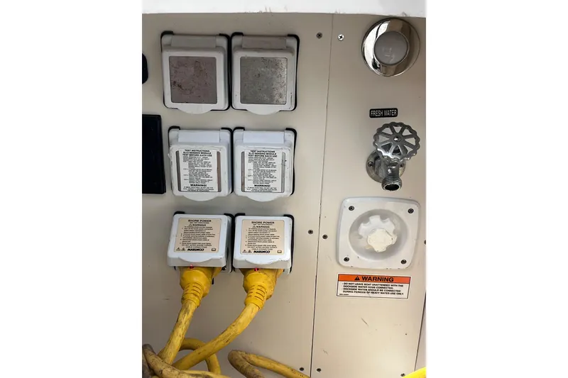 Slide: The Image of 2020 Sea Ray Sundancer 320 Outboard power and water connections panel. - 77