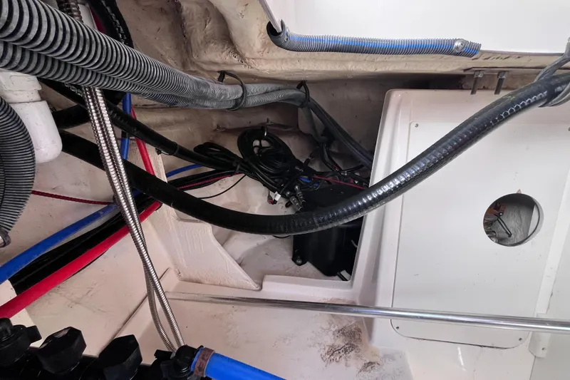 Slide: The Image of Engine compartment of 2020 Sea Ray Sundancer 320 Outboard with visible wiring and hoses. - 81