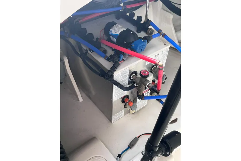 Slide: The Image of Engine compartment of 2020 Sea Ray Sundancer 320 Outboard with visible wiring and components. - 90