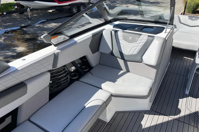Slide: The Image of 2022 Nautique Super Air Nautique G25 interior with gray seating and sleek design. - 10