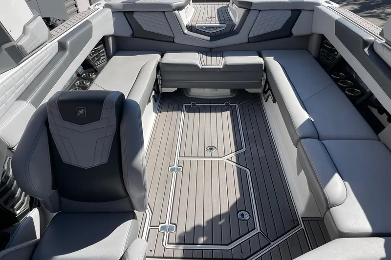 Slide: The Image of 2022 Nautique Super Air Nautique G25 interior with luxurious seating and sleek design. - 12