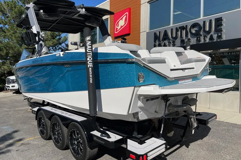Slide: The Image of 2022 Nautique Super Air Nautique G25 boat on trailer outside dealership. - 3