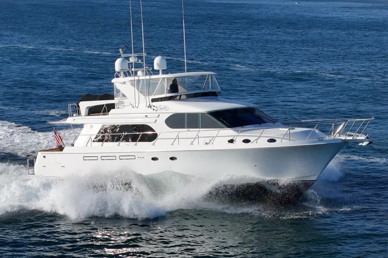 Slide: The Image of 2006 Ocean Alexander 64 Pilothouse yacht cruising on open water. - 12