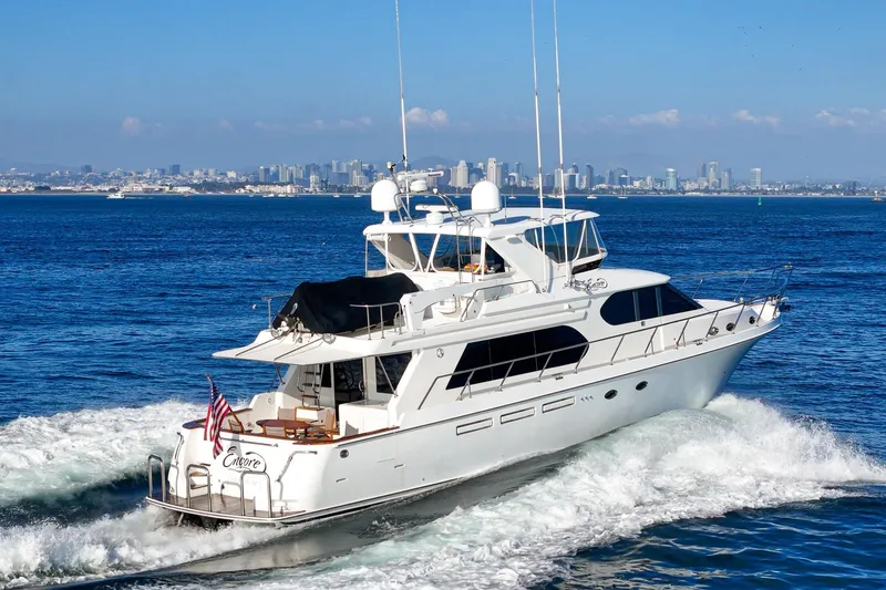 Slide: The Image of Luxury 2006 Ocean Alexander 64 Pilothouse yacht cruising near city skyline. - 16