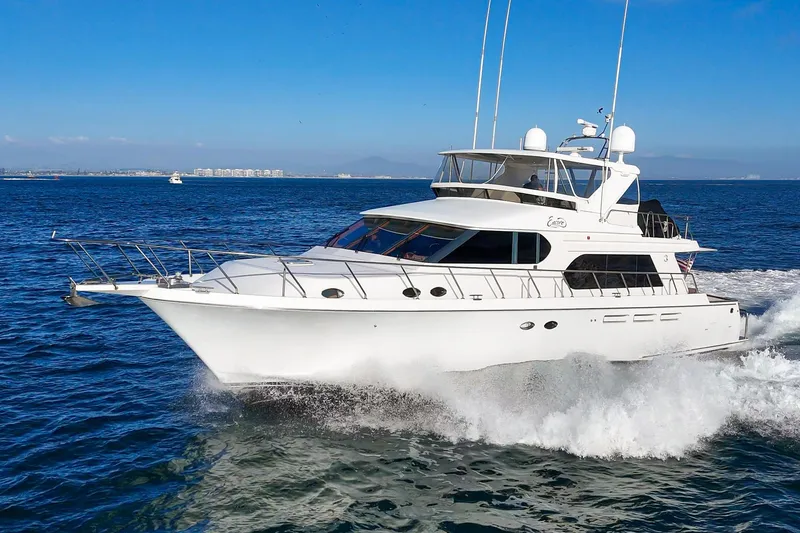 Slide: The Image of 2006 Ocean Alexander 64 Pilothouse yacht cruising on open water under clear blue skies. - 20