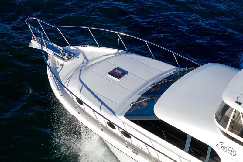 Slide: The Image of 2006 Ocean Alexander 64 Pilothouse yacht cruising on open water. - 23