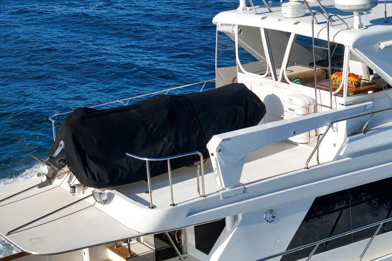 Slide: The Image of 2006 Ocean Alexander 64 Pilothouse yacht with covered equipment on deck, cruising on blue waters. - 26