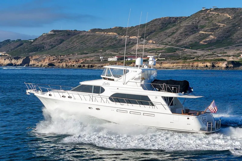 Slide: The Image of 2006 Ocean Alexander 64 Pilothouse yacht cruising near scenic coastline. - 3