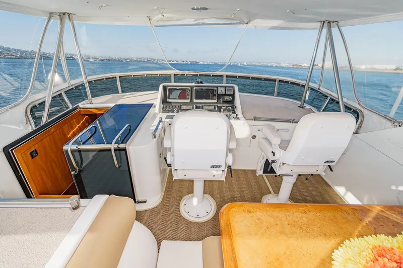 Slide: The Image of Pilothouse of 2006 Ocean Alexander 64, featuring dual helm seats and panoramic ocean view. - 30