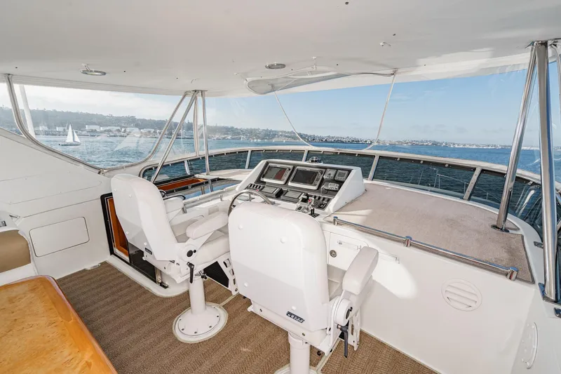 Slide: The Image of Pilothouse of 2006 Ocean Alexander 64, featuring dual captain chairs and navigation equipment. - 31