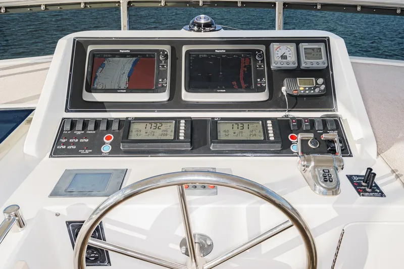 Slide: The Image of Pilothouse of 2006 Ocean Alexander 64, featuring navigation controls and dual displays. - 33