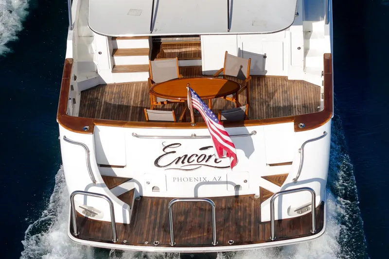 Slide: The Image of Rear view of 2006 Ocean Alexander 64 Pilothouse yacht with American flag and deck seating. - 34