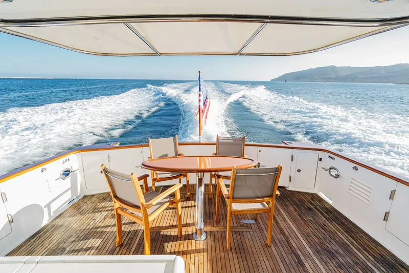 Slide: The Image of Ocean Alexander 64 Pilothouse 2006 yacht deck with chairs, table, and ocean view. - 40