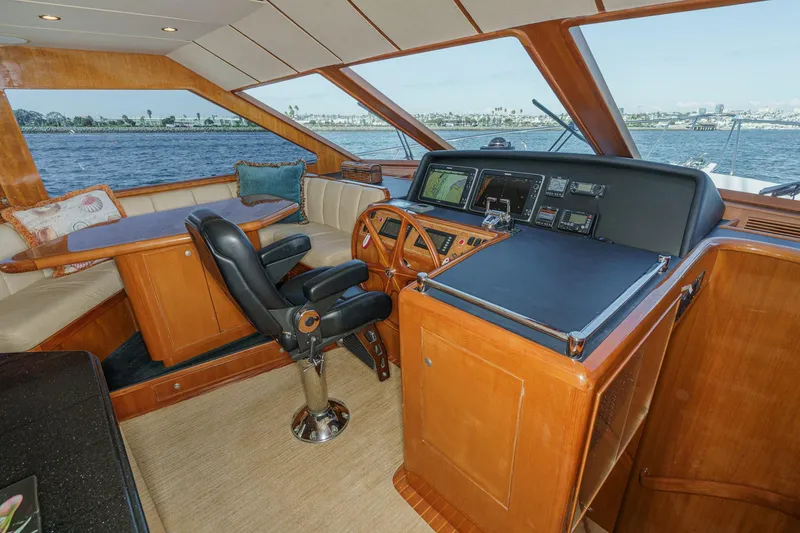 Slide: The Image of Pilothouse interior of 2006 Ocean Alexander 64, featuring helm and seating area with ocean view. - 48