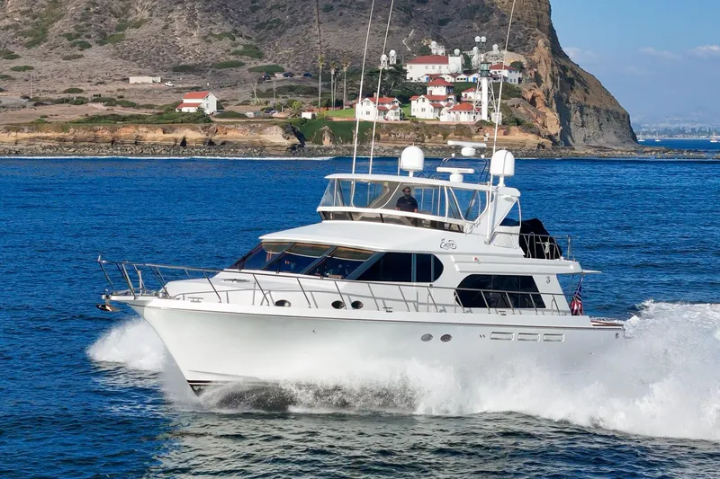 Slide: The Image of 2006 Ocean Alexander 64 Pilothouse yacht cruising near rocky coastline. - 6