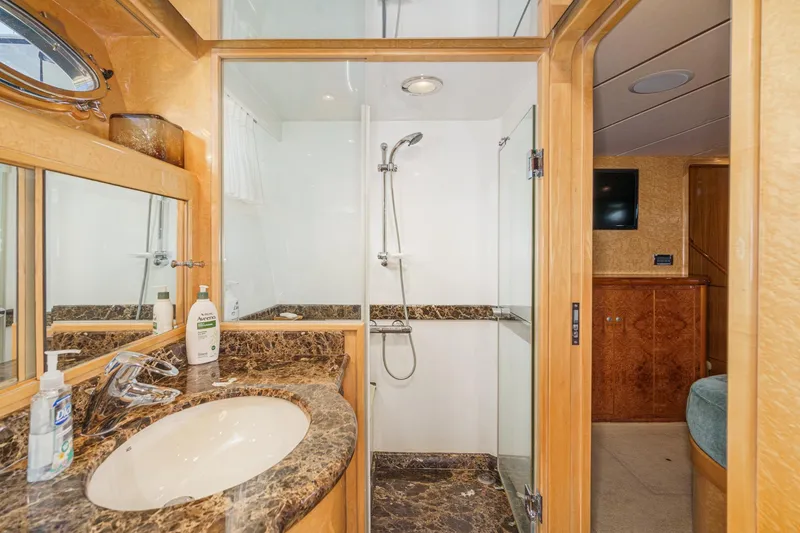 Slide: The Image of Luxurious bathroom in 2006 Ocean Alexander 64 Pilothouse yacht with marble countertop and glass shower. - 60