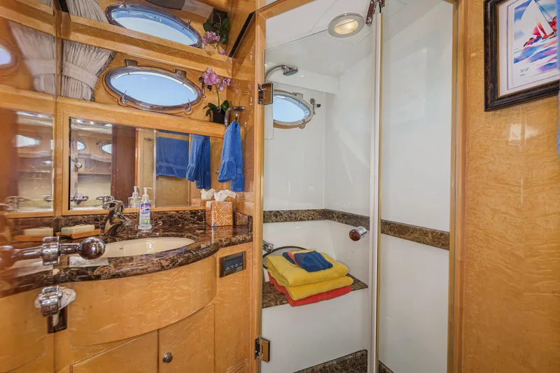 Slide: The Image of Luxurious bathroom in 2006 Ocean Alexander 64 Pilothouse yacht with elegant wood and marble finishes. - 64