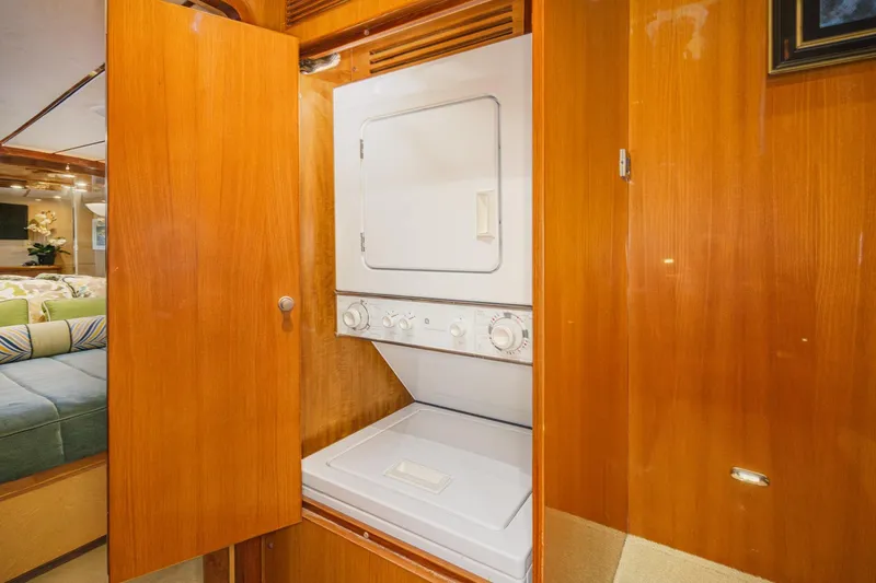 Slide: The Image of Laundry area in 2006 Ocean Alexander 64 Pilothouse yacht with wood cabinetry. - 65