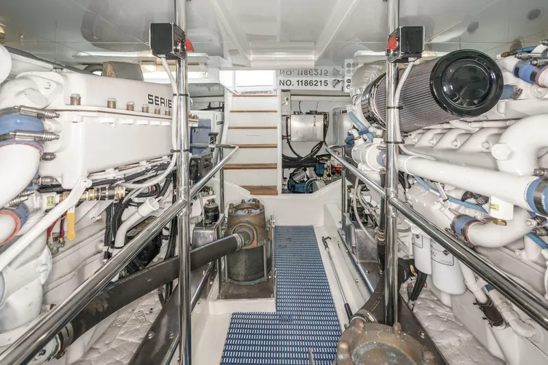 Slide: The Image of Engine room of 2006 Ocean Alexander 64 Pilothouse yacht, showcasing dual engines and equipment. - 66