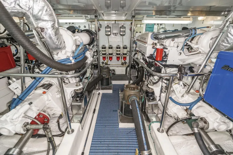 Slide: The Image of Engine room of 2006 Ocean Alexander 64 Pilothouse yacht, showcasing dual engines and mechanical systems. - 67