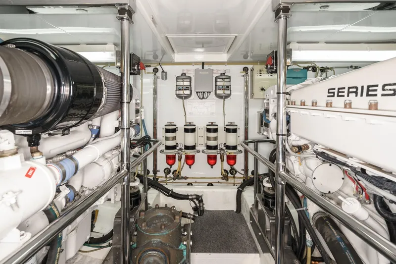 Slide: The Image of Engine room of 2006 Ocean Alexander 64 Pilothouse yacht, showcasing mechanical components and systems. - 68