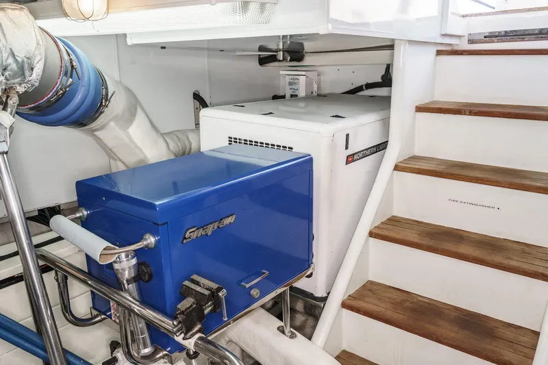 Slide: The Image of Engine room of 2006 Ocean Alexander 64 Pilothouse with generator and tool storage. - 74