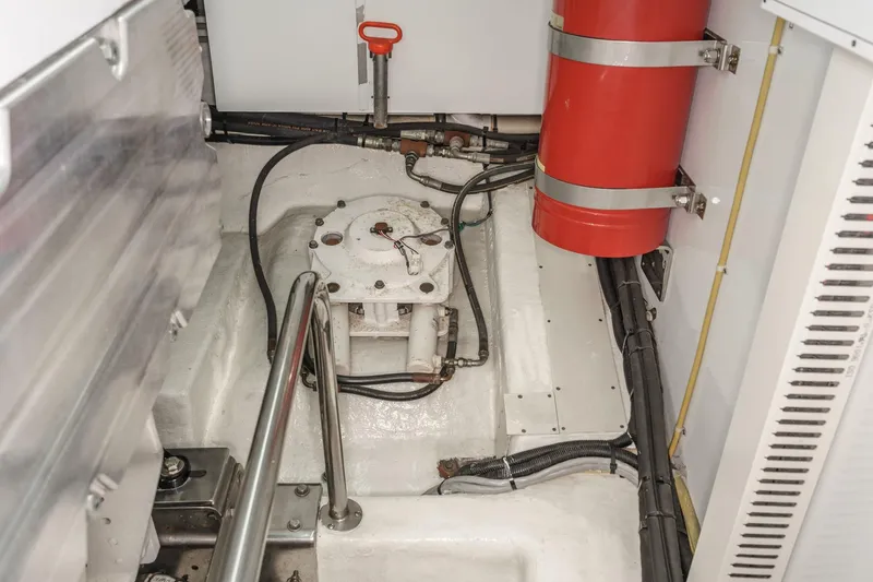 Slide: The Image of Engine room of 2006 Ocean Alexander 64 Pilothouse yacht with fire extinguisher and piping. - 76